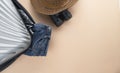 Flat lay grey suitcase with binoculars, hat, jeans on pastel background. travel concept - Image Royalty Free Stock Photo