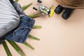 Flat lay grey suitcase with jeans, spinning of fishing tools, binoculars, hat, on pastel background. travel concept - Image