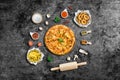 Flat lay Grilled beef steak on wooden cutting board and ingredient. Crispy Onion rings and french fries with sauce. Top view with Royalty Free Stock Photo