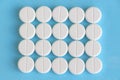 Group of white round pills on a blue background Royalty Free Stock Photo