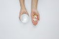 Flat lay hand holding pills glass water. High quality and resolution beautiful photo concept Royalty Free Stock Photo