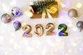 Flat lay happy new year golden numbers 2022 on light background with bokeh, greeting card with craft gifts Royalty Free Stock Photo
