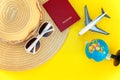 Flat Lay with hat, plane, passport, globe and sunglasses on yellow colourful trendy modern fashion background. Vacation travel Royalty Free Stock Photo