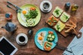 flat lay with healthy breakfast for two with fried eggs, toasts, vegetables and cups of coffee