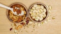 Flat lay of healthy grain concept, Pistachios and almond in wooden bowl and beans on wood table