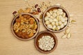 Flat lay of healthy grain concept, Pistachios and almond in wooden bowl and beans on wood table