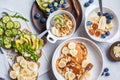 Flat lay of healthy vegetarian breakfast. Oatmeal with fruits, chia pudding, pancakes with banana and honey and toasts with fruits