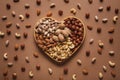 Flat lay with heart shaped box with different nuts assortment