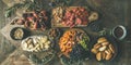 Meat, cheese, olives, sandwiches, prosciutto, buns on wooden background