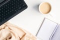 Flat lay home office desk. Female workspace with laptop computer, cup of coffee, paper notepad, plaid. Top view feminine Royalty Free Stock Photo