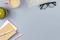 Flat lay home office desk. Female workspace with note book, eyeglasses, tea mug, diary, plant. Copy space Royalty Free Stock Photo