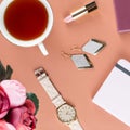 Flat lay home office desk. Female workspace with note pad, flowers, tea, chocolate cookies and fashion accessories. Fashion or bea Royalty Free Stock Photo