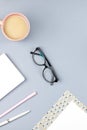 Flat lay home office desk. Female workspace with planner, eyeglasses, tea mug, diary, plant. Copy space Royalty Free Stock Photo