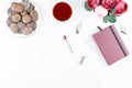 Flat lay home office desk. Feminine workspace with diary, flowers, sweets, fashion accessories. Fashion blogger concept. Royalty Free Stock Photo