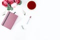 Flat lay home office desk. Feminine workspace with diary, flowers, sweets, fashion accessories. Fashion blogger concept.