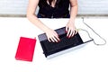 Girl`s hands typing on the keyboard. Workspace with girl`s hands, laptop, pink peony bouquet, golden accessories, mint diary. To Royalty Free Stock Photo