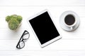 Flat lay home office workspace. Tablet, glasses, cup of coffee, succulent on white wooden background. Top view Business, freelance