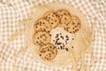 Flat lay of homemade sweets, Chocolate chip cookie in rattan plate on brown gingham cloth