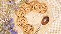 Flat lay of homemade sweets, Chocolate chip cookies on rattan plate over brown gingham cloth Royalty Free Stock Photo