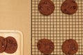 Flat lay of homemade sweets, Chocolate cookie on rack and stack in wooden tray over wood background Royalty Free Stock Photo