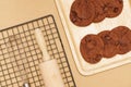 Flat lay of homemade sweets, Chocolate cookie are stack on wooden tray with confectionery equipment Royalty Free Stock Photo