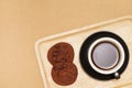 Flat lay of homemade sweets, Chocolate cookies and hot coffee on wooden tray over wood background Royalty Free Stock Photo