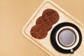 Flat lay of homemade sweets, Chocolate cookies and hot coffee on wooden tray over wood background Royalty Free Stock Photo