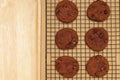 Flat lay of homemade sweets, Chocolate cookies on rack with wooden tray on wood background Royalty Free Stock Photo