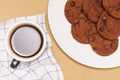 Flat lay of homemade sweets, Chocolate cookies are stack on plate and coffee over wood background Royalty Free Stock Photo