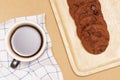 Flat lay of homemade sweets, Chocolate cookies are stack on plate and coffee over wood background Royalty Free Stock Photo