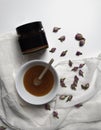 Flat lay of honey in a small bowl, wooden honey dipper, silk, petals and dried roses on a white background and jar with honey. Top Royalty Free Stock Photo