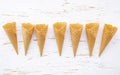 Flat lay ice cream cones collection on shabby wooden background . Blank crispy ice cream cone with copy space for sweets menu Royalty Free Stock Photo