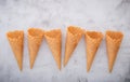 Flat lay ice cream cones collection on white concrete background . Blank crispy ice cream cone with copy space for sweets menu Royalty Free Stock Photo