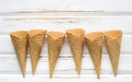 Flat lay ice cream cones collection on white wooden background . Blank crispy ice cream cone with copy space for sweets menu Royalty Free Stock Photo