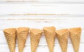 Flat lay ice cream cones collection on white wooden background . Blank crispy ice cream cone with copy space for sweets menu Royalty Free Stock Photo