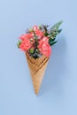 Flat lay Ice Cream Cones with colorful bouquet on blue background Royalty Free Stock Photo