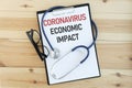 Flat lay of an image with `CORONAVIRUS ECONOMIC IMPACT` Royalty Free Stock Photo
