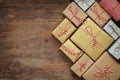 Flat lay image of handmade gift boxes over wooden background