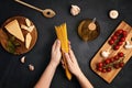 Flat lay of Ingredients for cooking italian pasta. Spaghetti, tomatoes, oil, garlic, parmezan. Top view of traditional italian cus Royalty Free Stock Photo