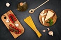 Flat lay of Ingredients for cooking italian pasta. Spaghetti, tomatoes, oil, garlic, parmezan. Top view of traditional italian cus Royalty Free Stock Photo