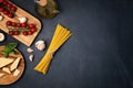 Flat lay of Ingredients for cooking italian pasta. Spaghetti, tomatoes, oil, garlic, parmezan. Top view of traditional italian cus Royalty Free Stock Photo