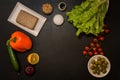 Flat lay. Italian food. Plant based ingredients for vegan greek salad on black background. Copy space