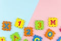 Flat lay Learning toys puzzle with numbers and letters on geometric blue and pink pastel background with copy space Royalty Free Stock Photo