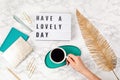 Flat lay with lightbox with text Have a lovely day and coffee cup. Social media, motivation quote, feminine blog, morning of