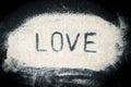 Flat lay of Love word written on sand Royalty Free Stock Photo