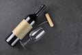Flat lay of lying red wine bottle with empty label, corkscrew and glass for tasting Royalty Free Stock Photo
