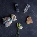 Flat lay Magic composition with crystals, pagan bag and rose flowers. Esoteric and pagan rituals, witchcraft Wiccan or spiritual