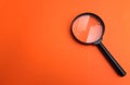 Flat lay Magnifying glass  on a orange background Royalty Free Stock Photo