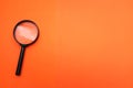 Flat lay Magnifying glass  on a orange background Royalty Free Stock Photo