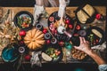 Flat-lay of man pouring champagne to glass at Thanksgiving table Royalty Free Stock Photo